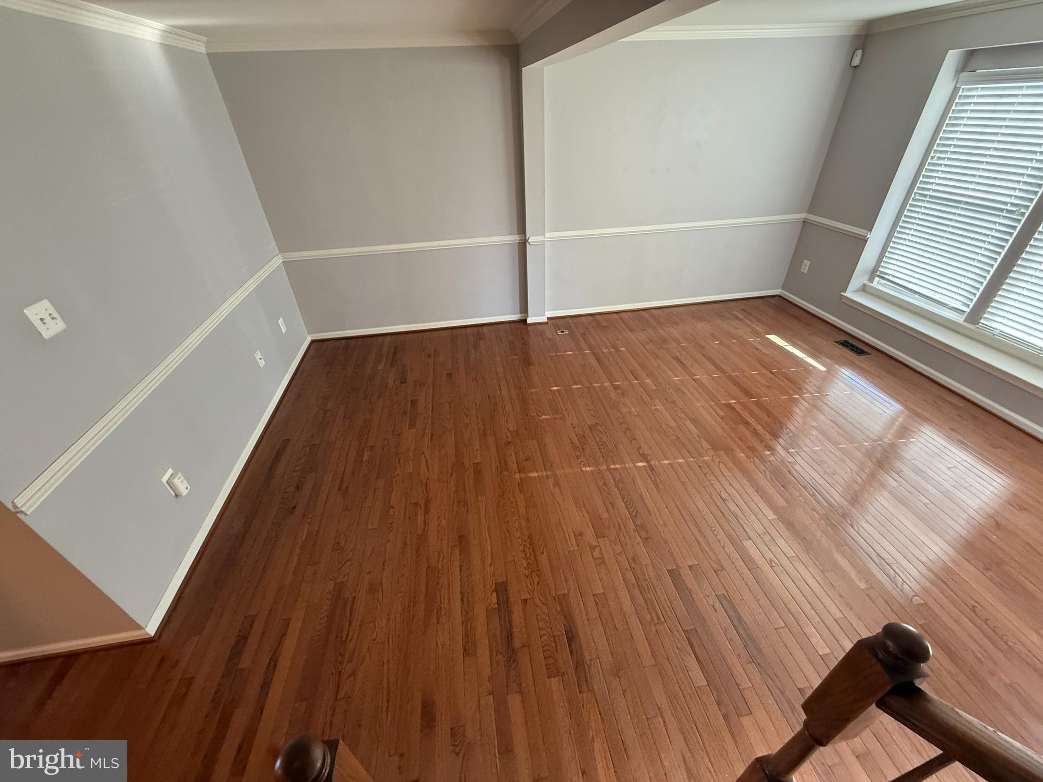 7088 Maiden Point Place, Unit 25 Elkridge, MD 21075 - Photo 6 of 16 a view of an empty room with wooden floor and a window