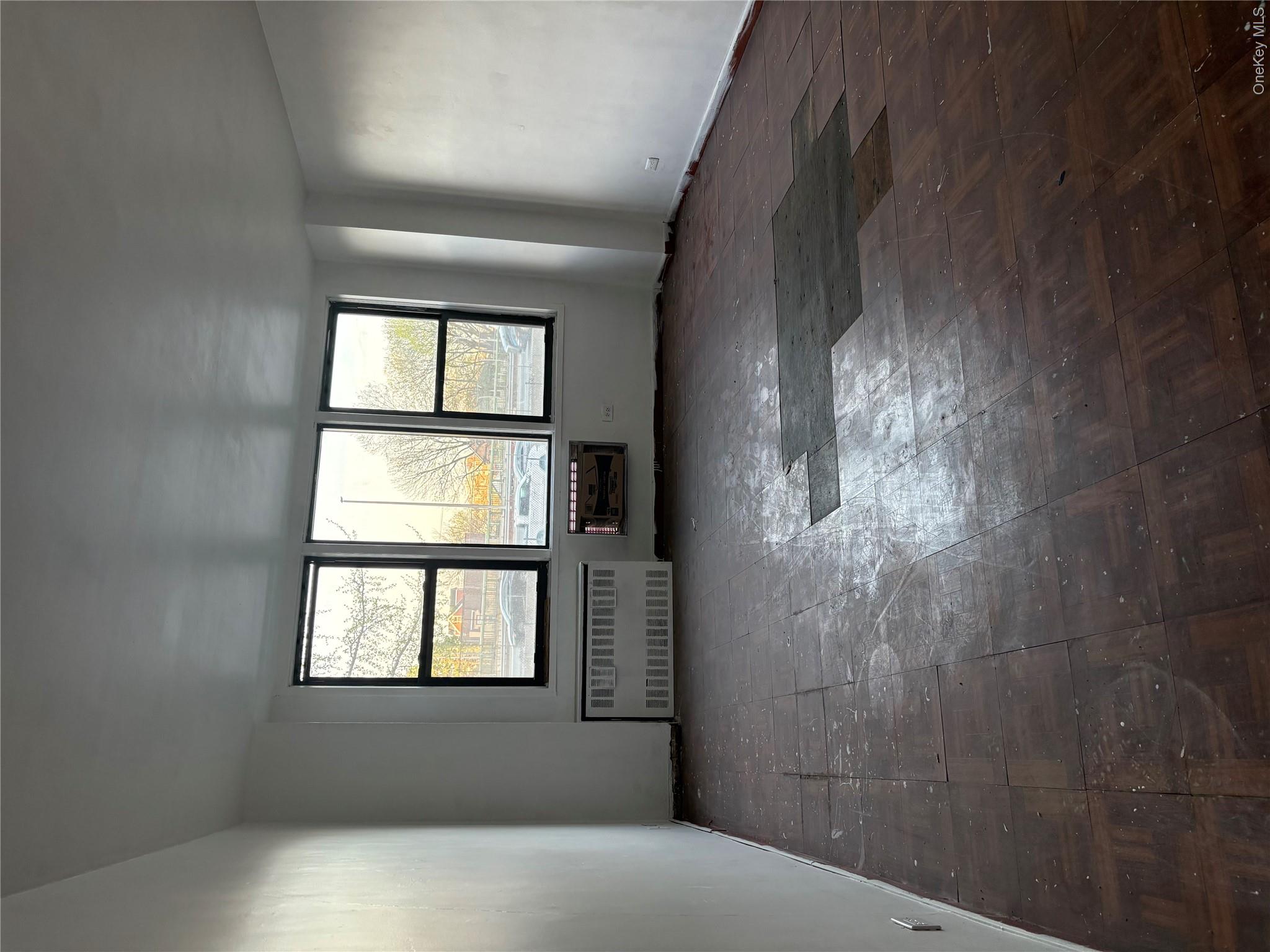 3121 Middletown Road, Unit 1G Bronx, NY 10461 - Photo 15 of 19 a view of an empty room with a window and a kitchen