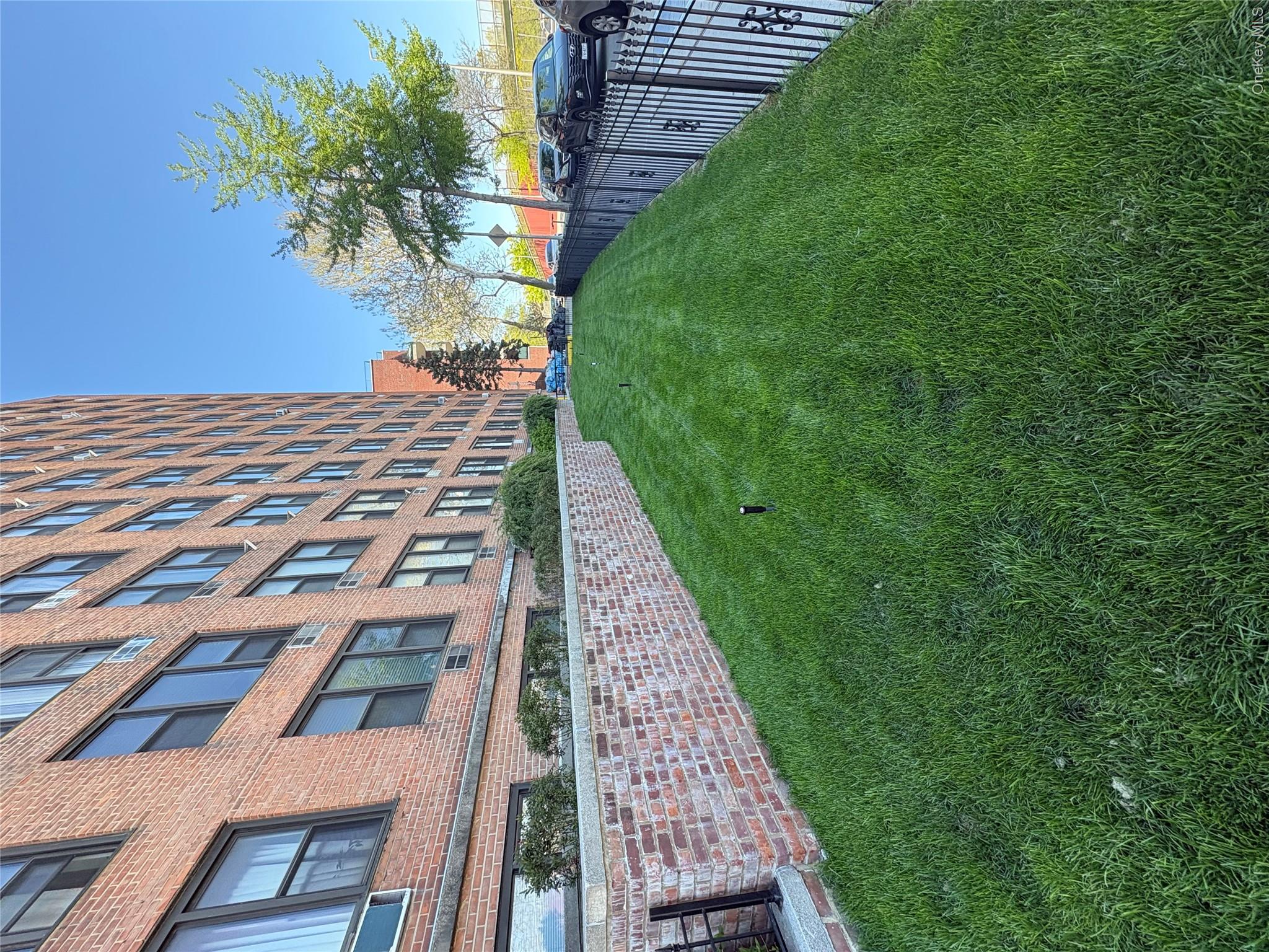 3121 Middletown Road, Unit 1G Bronx, NY 10461 - Photo 4 of 19 a view of a building next to a big yard and large trees