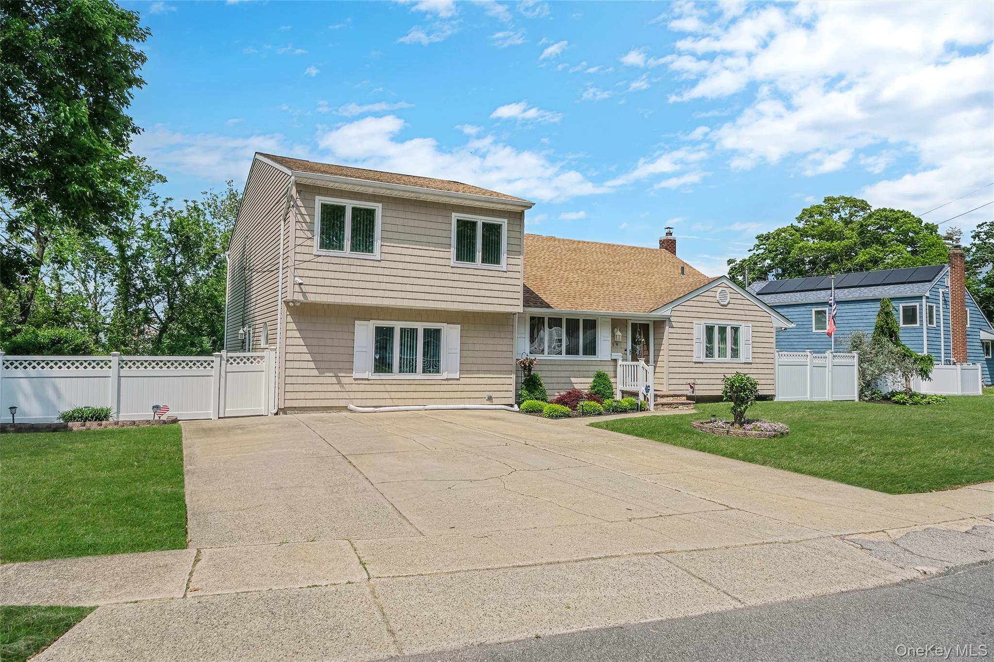 59 Maybrook Road North Babylon, NY 11703 - Photo 2 of 43 a front view of house with yard and green space