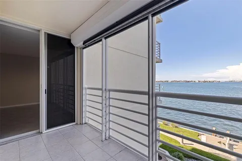 an empty room with closet and chandelier fan