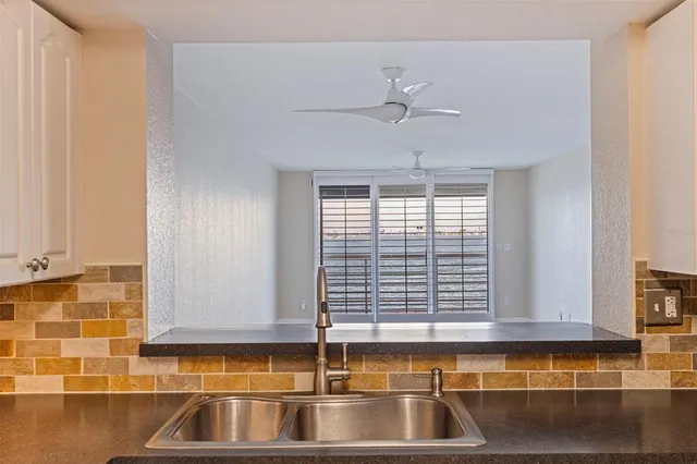 a kitchen with appliances a sink and cabinets