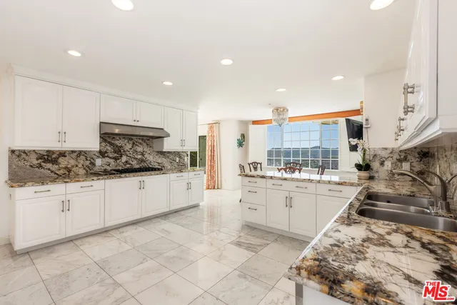 a large bathroom with a large tub and sink