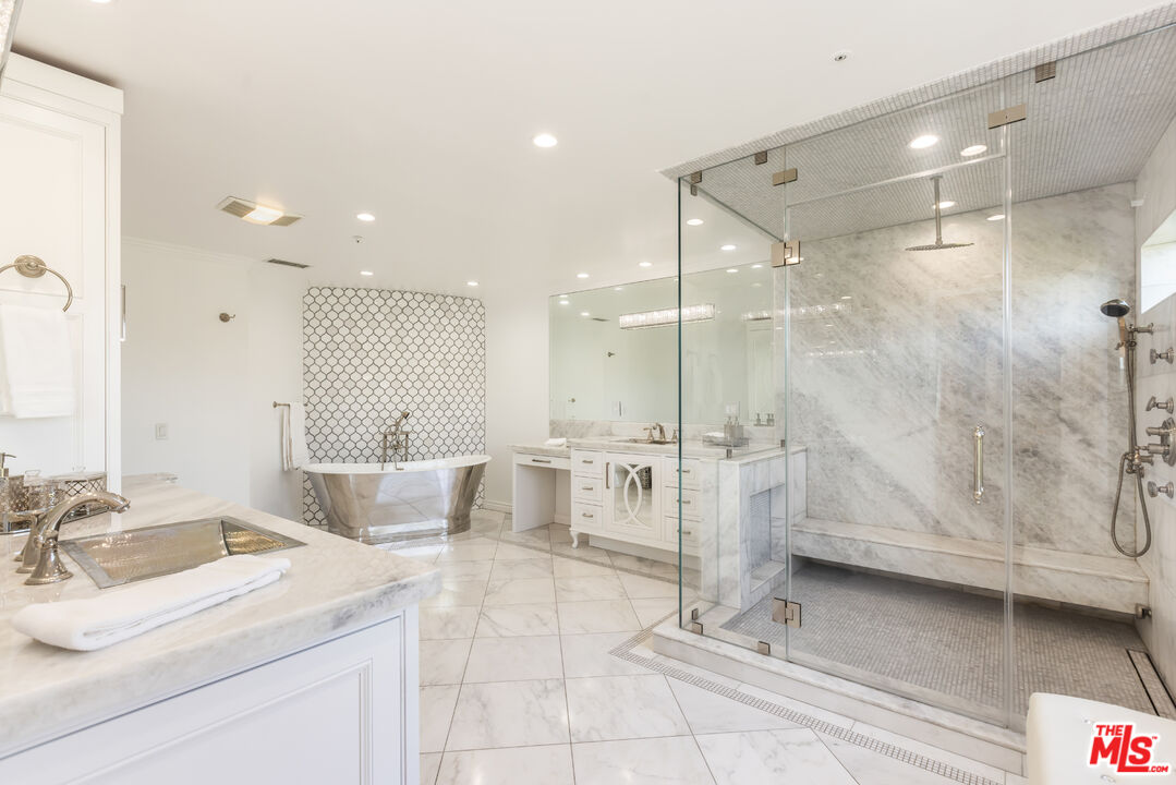 1957 Linda Flora Drive Los Angeles, CA 90077 - Photo 20 of 48 a bathroom with a double vanity sink a mirror and a shower