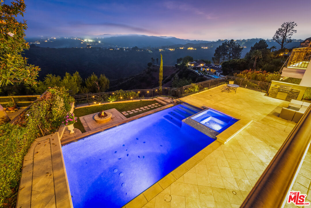 1957 Linda Flora Drive Los Angeles, CA 90077 - Photo 2 of 48 a view of a pool with a patio
