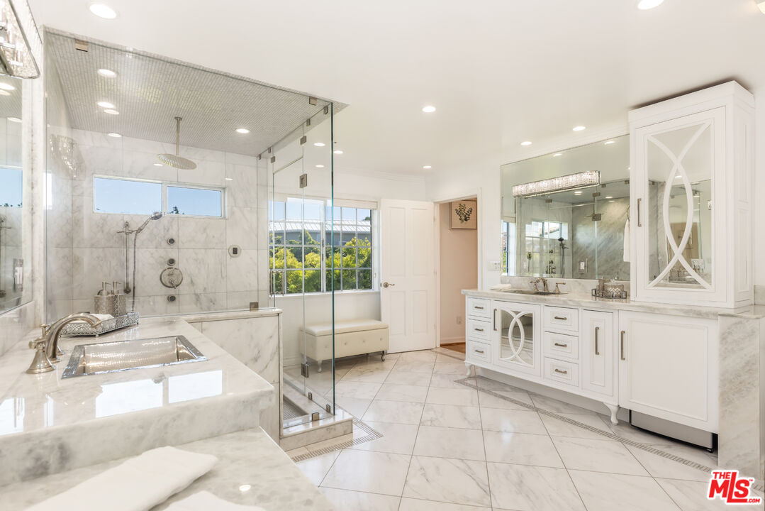 1957 Linda Flora Drive Los Angeles, CA 90077 - Photo 22 of 48 a large bathroom with a granite countertop sink mirror and a bath tub