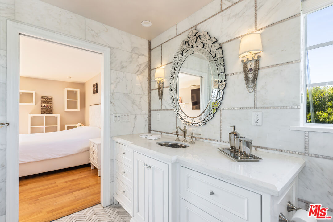 1957 Linda Flora Drive Los Angeles, CA 90077 - Photo 33 of 48 a bathroom with a sink and a mirror