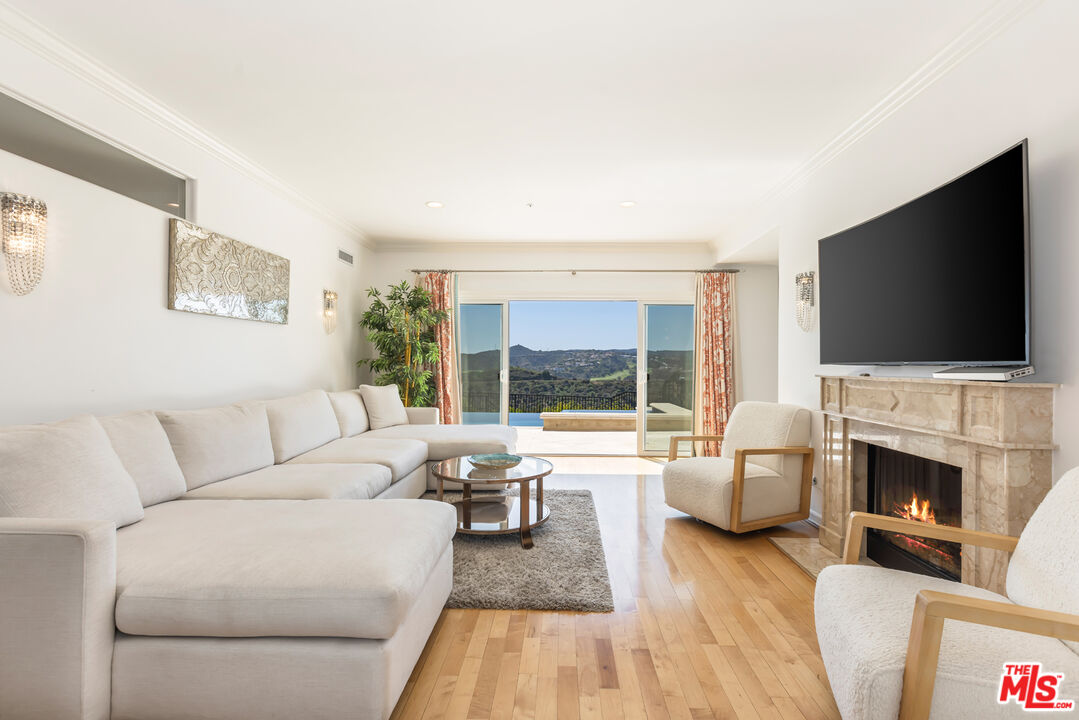 1957 Linda Flora Drive Los Angeles, CA 90077 - Photo 9 of 48 a living room with fireplace furniture and a flat screen tv