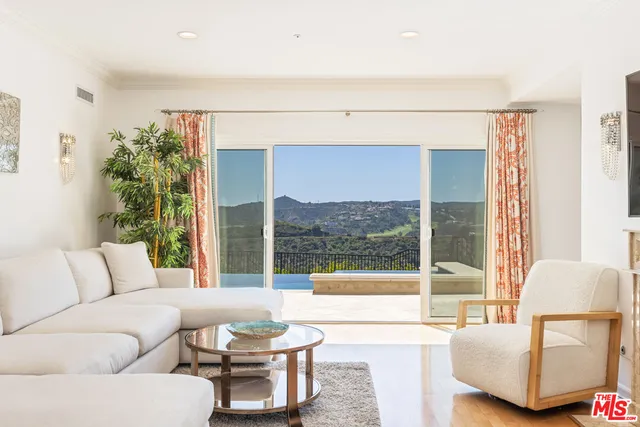 a view of a balcony with a yard and mountain view