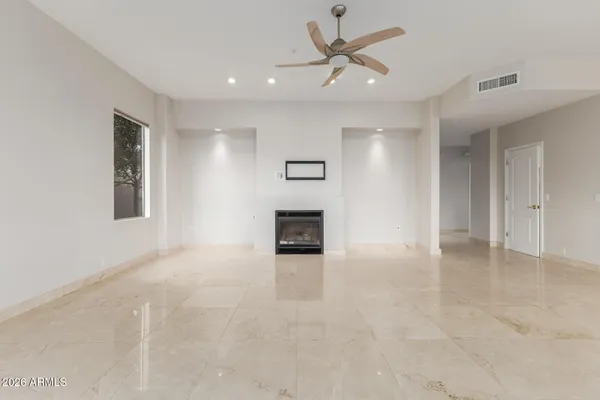 a living room with furniture and kitchen view
