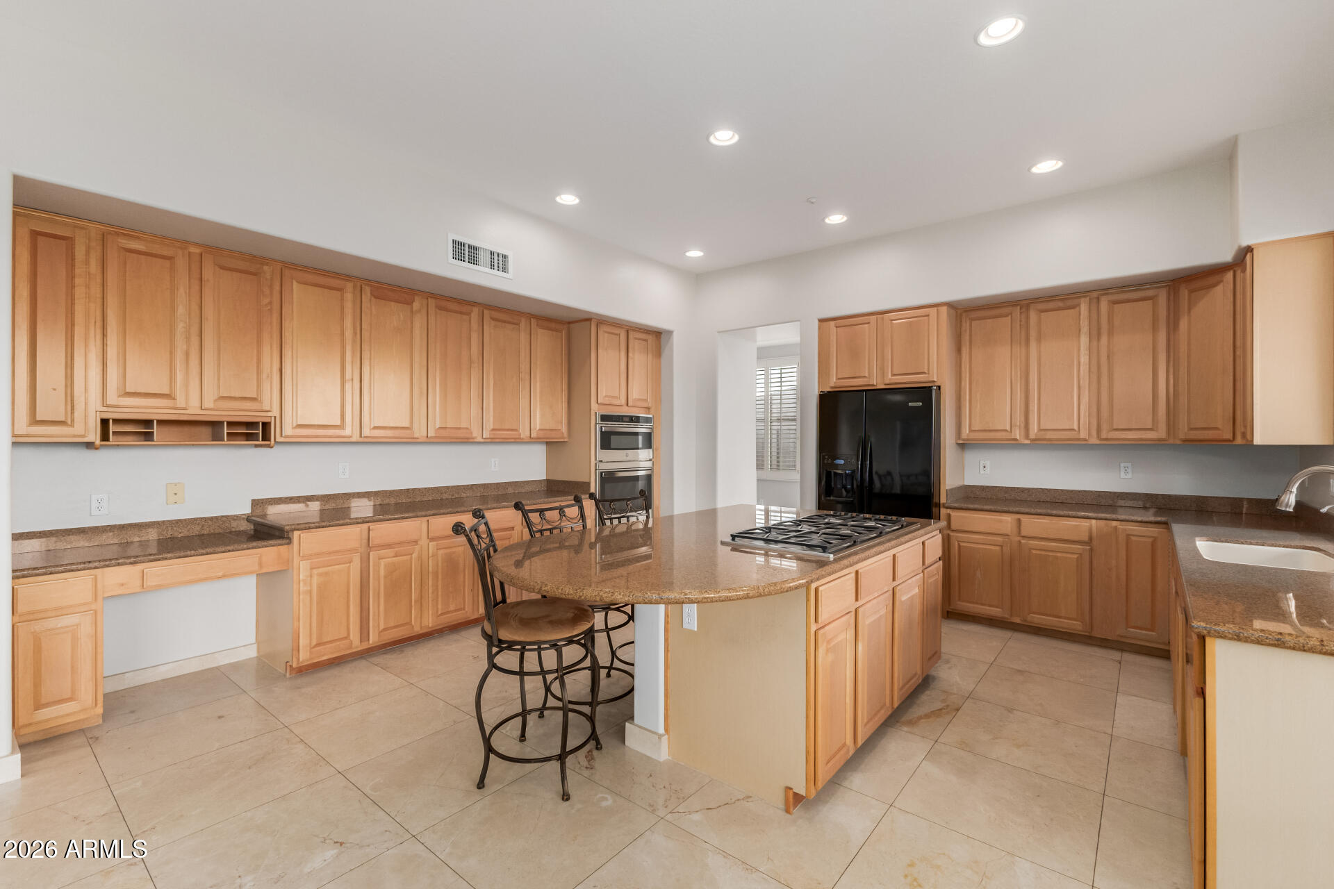 10872 East Raintree Drive Scottsdale, AZ 85255 - Photo 18 of 54 a kitchen with stainless steel appliances granite countertop a stove top oven a sink a refrigerator and white cabinets