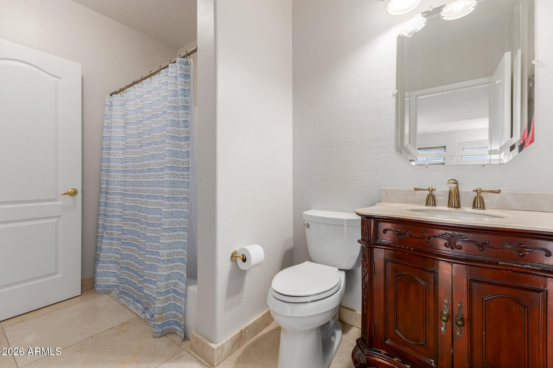 10872 East Raintree Drive Scottsdale, AZ 85255 - Photo 23 of 54 a bathroom with a toilet a sink a vanity and mirror