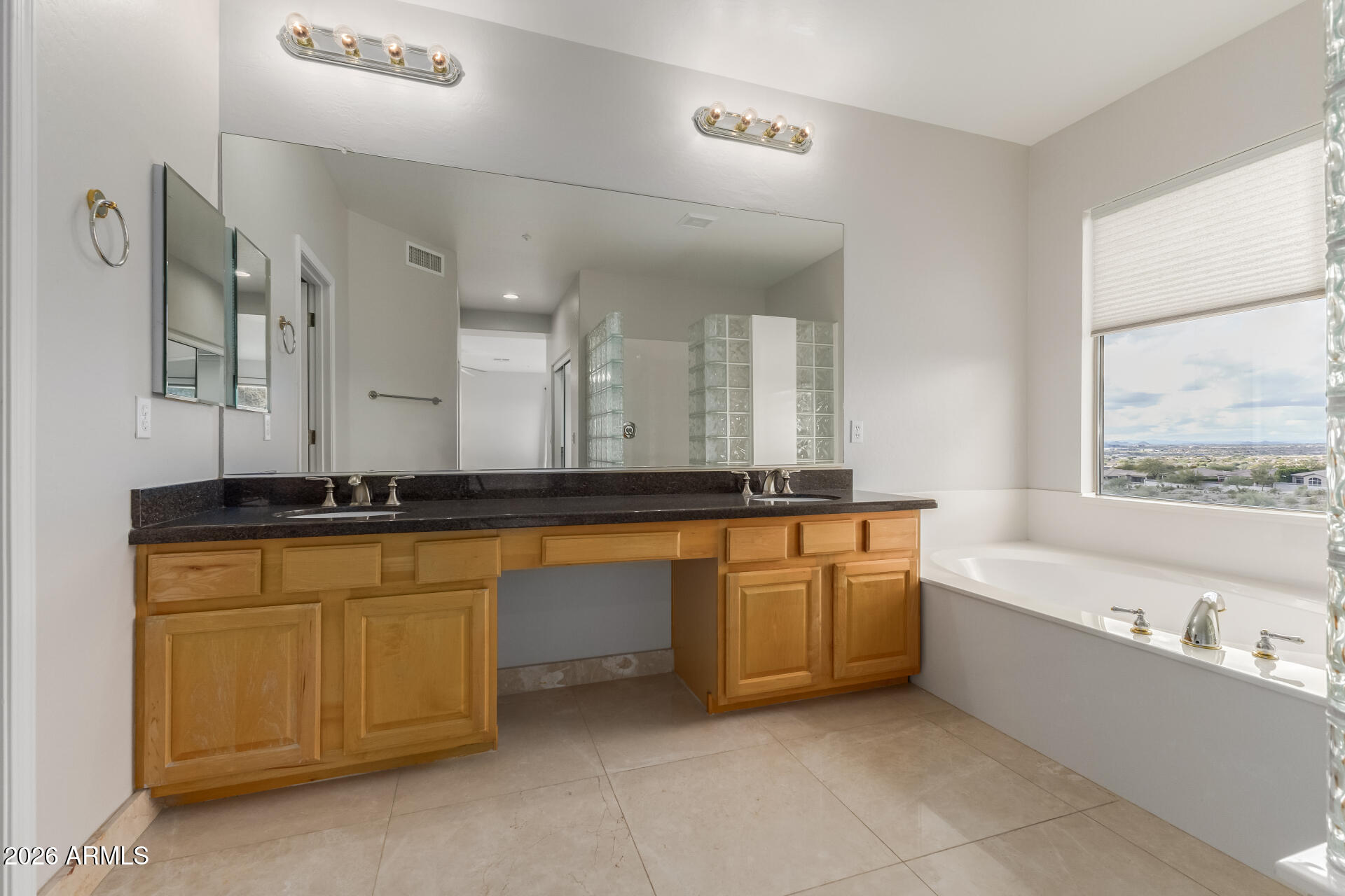 10872 East Raintree Drive Scottsdale, AZ 85255 - Photo 30 of 54 a bathroom with a granite countertop sink and a bathtub