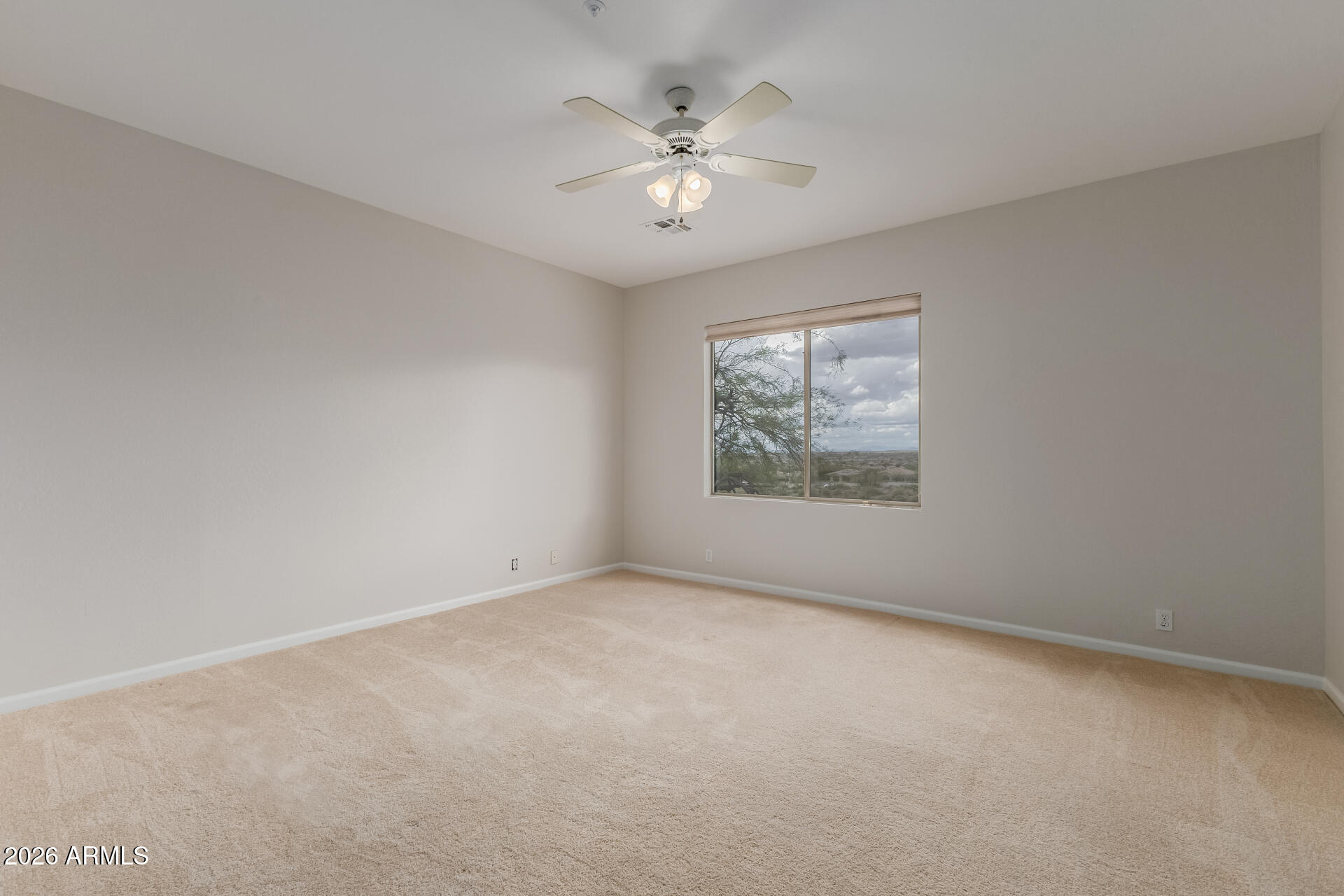 10872 East Raintree Drive Scottsdale, AZ 85255 - Photo 36 of 54 an empty room with windows and chandelier fan