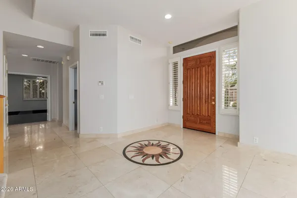 a view of a hallway with dining table and chair