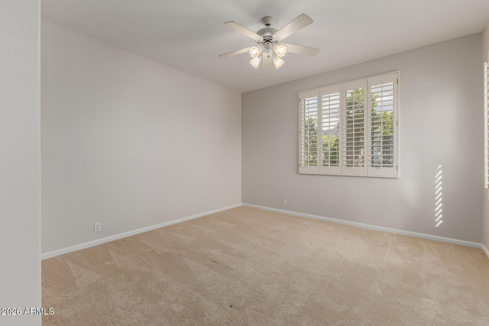 10872 East Raintree Drive Scottsdale, AZ 85255 - Photo 43 of 54 an empty room with a window and a fan