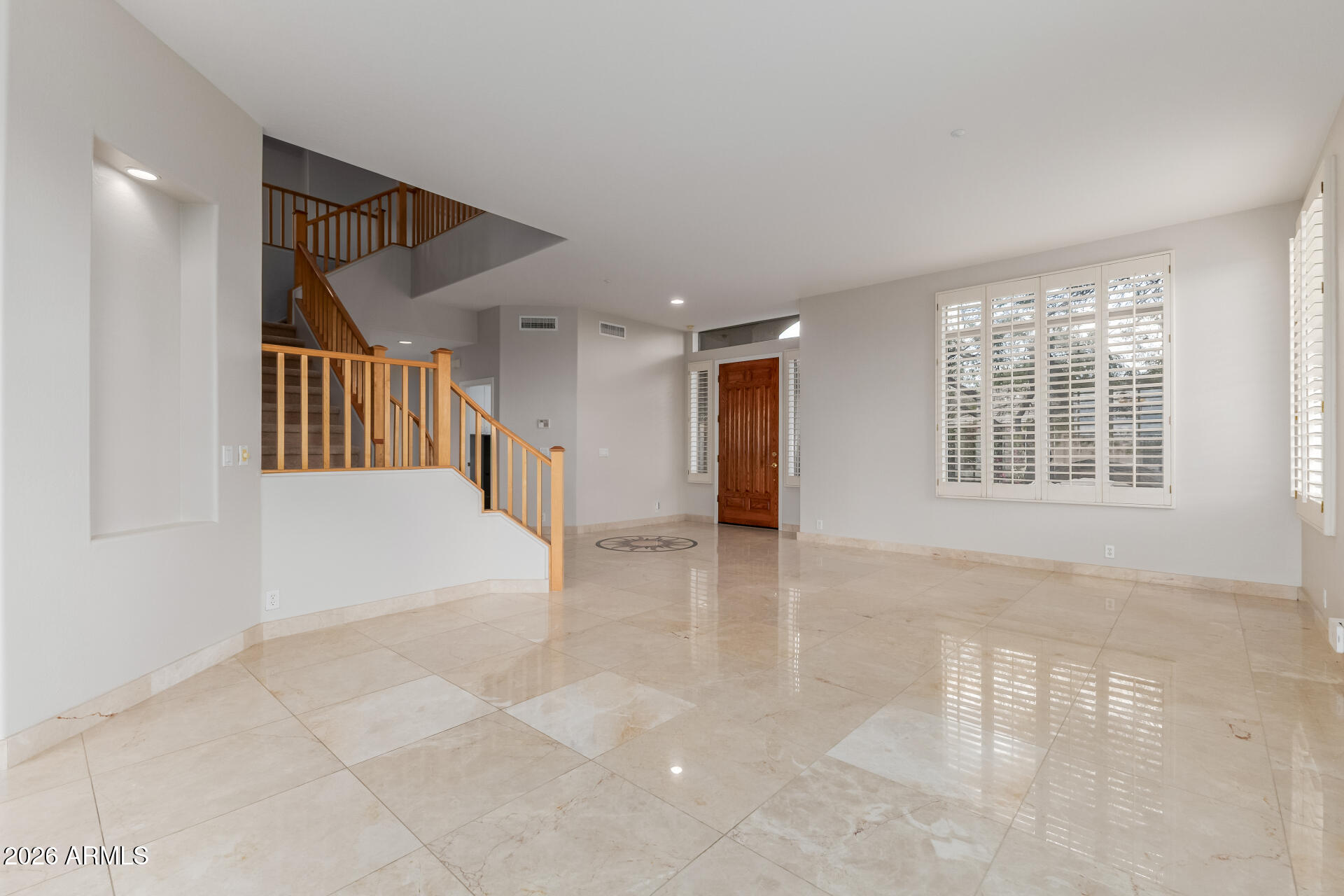 10872 East Raintree Drive Scottsdale, AZ 85255 - Photo 8 of 54 a view of an empty room with wooden floor and a window
