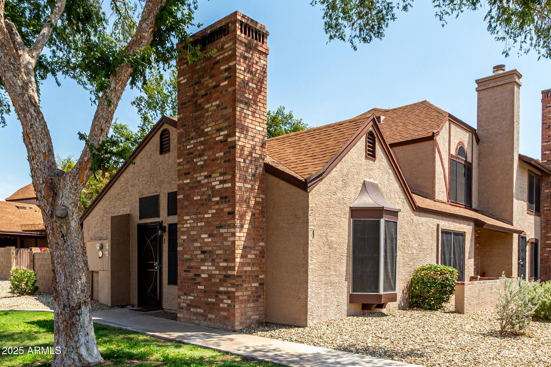 8111 West Wacker Road, Unit 1 Peoria, AZ 85381 - Photo 1 of 26 a view of a house with a tree