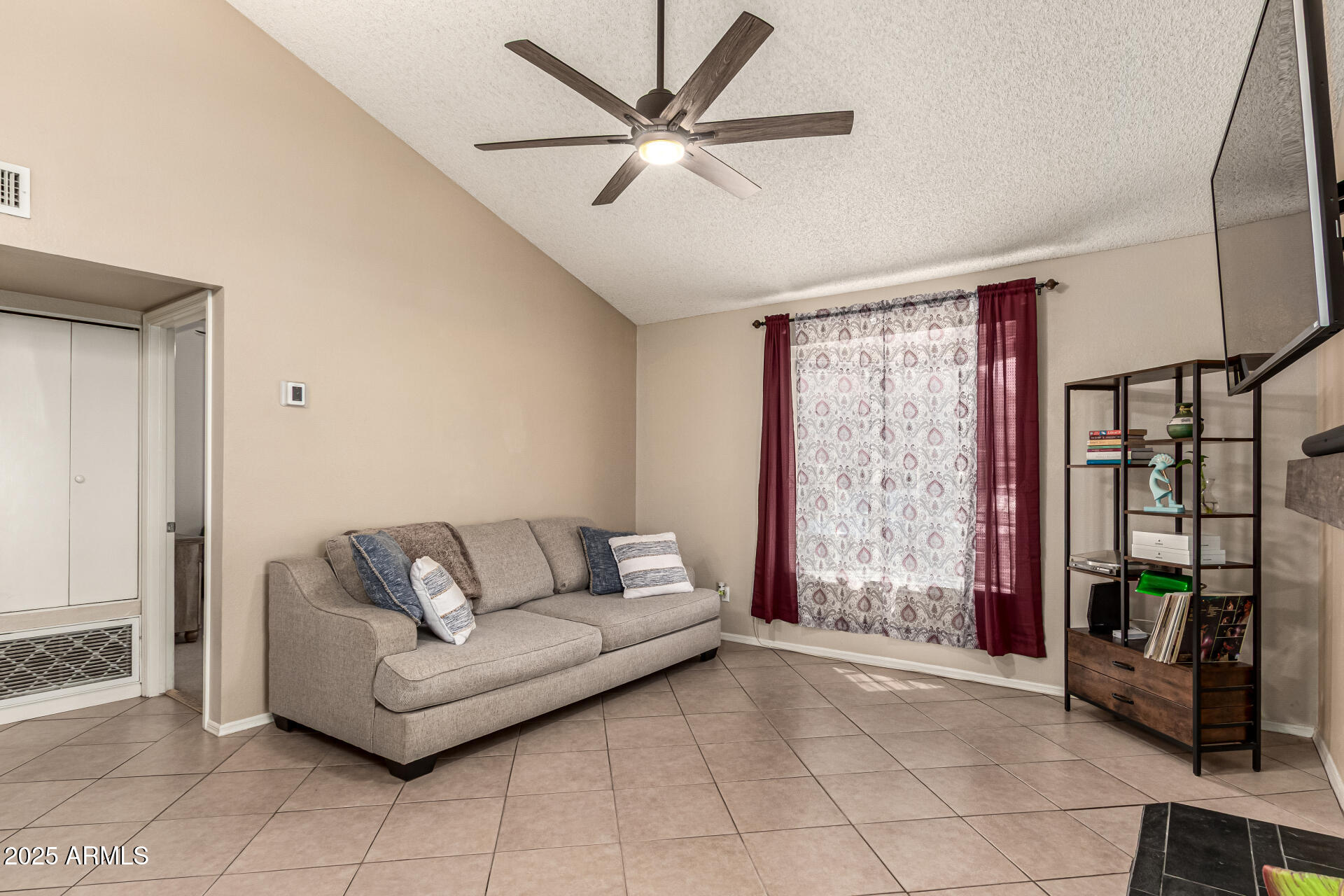 8111 West Wacker Road, Unit 1 Peoria, AZ 85381 - Photo 11 of 26 a living room with furniture and a flat screen tv