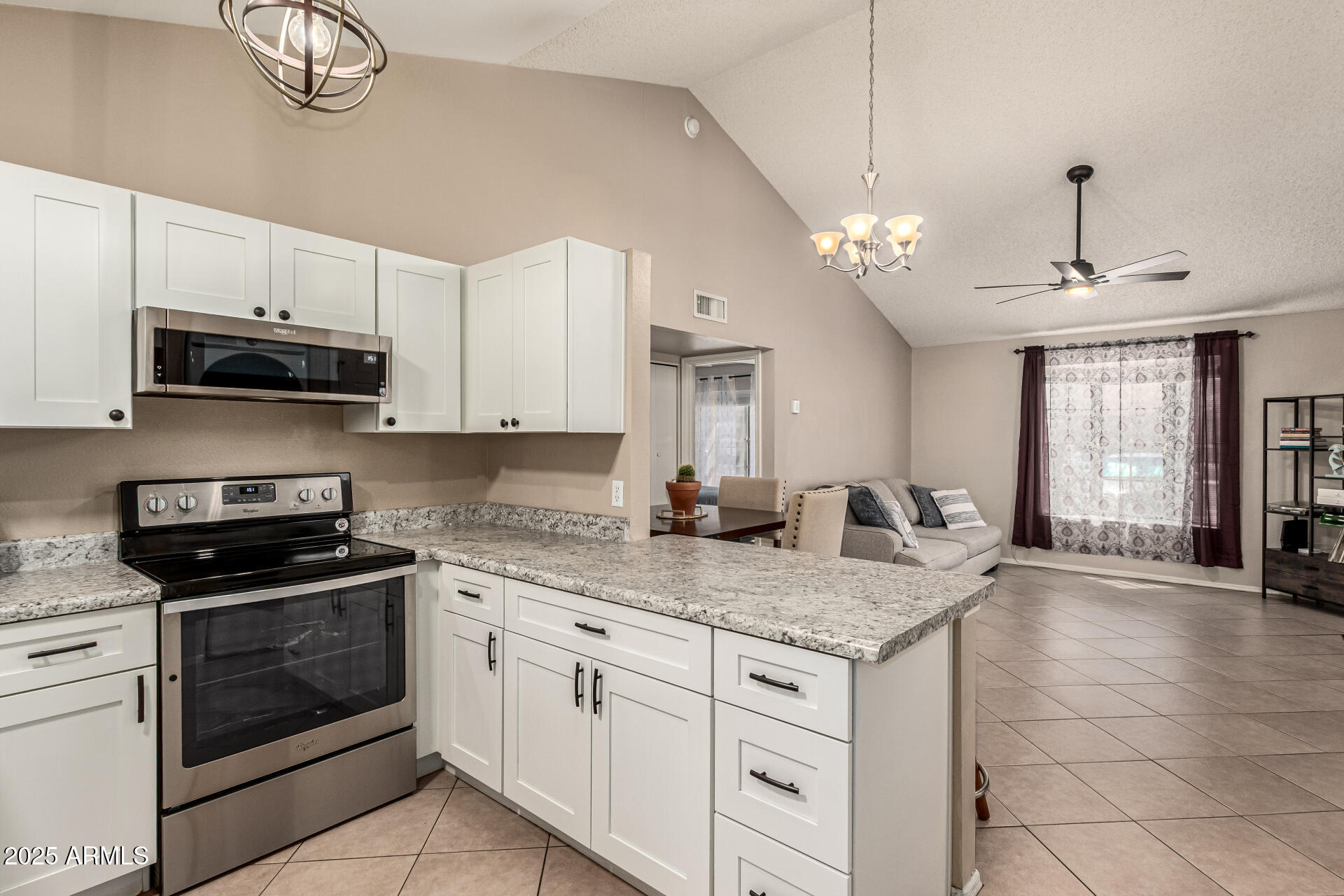8111 West Wacker Road, Unit 1 Peoria, AZ 85381 - Photo 12 of 26 a kitchen with granite countertop a sink a stove and cabinets