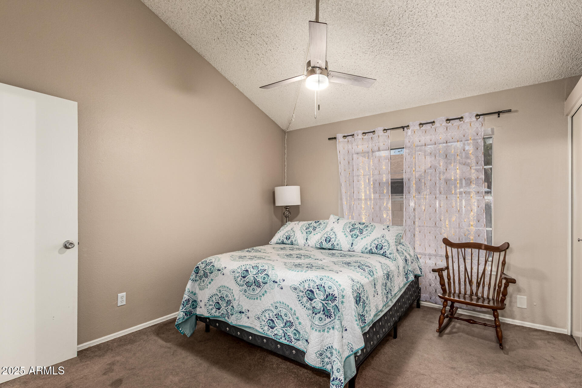 8111 West Wacker Road, Unit 1 Peoria, AZ 85381 - Photo 13 of 26 a bedroom with a bed and a chandelier