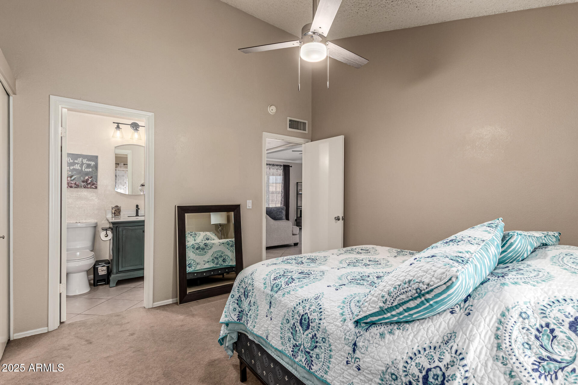 8111 West Wacker Road, Unit 1 Peoria, AZ 85381 - Photo 14 of 26 a bedroom with a large bed and a chandelier