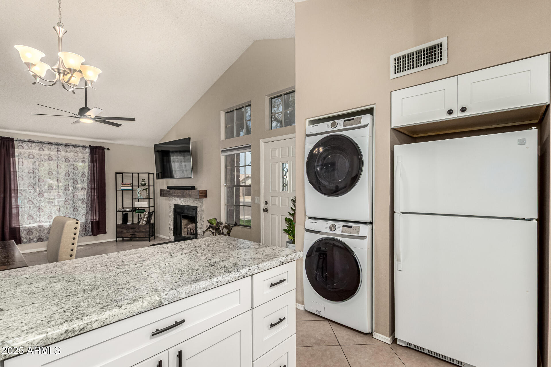8111 West Wacker Road, Unit 1 Peoria, AZ 85381 - Photo 22 of 26 a kitchen with stainless steel appliances granite countertop a sink a washer and dryer