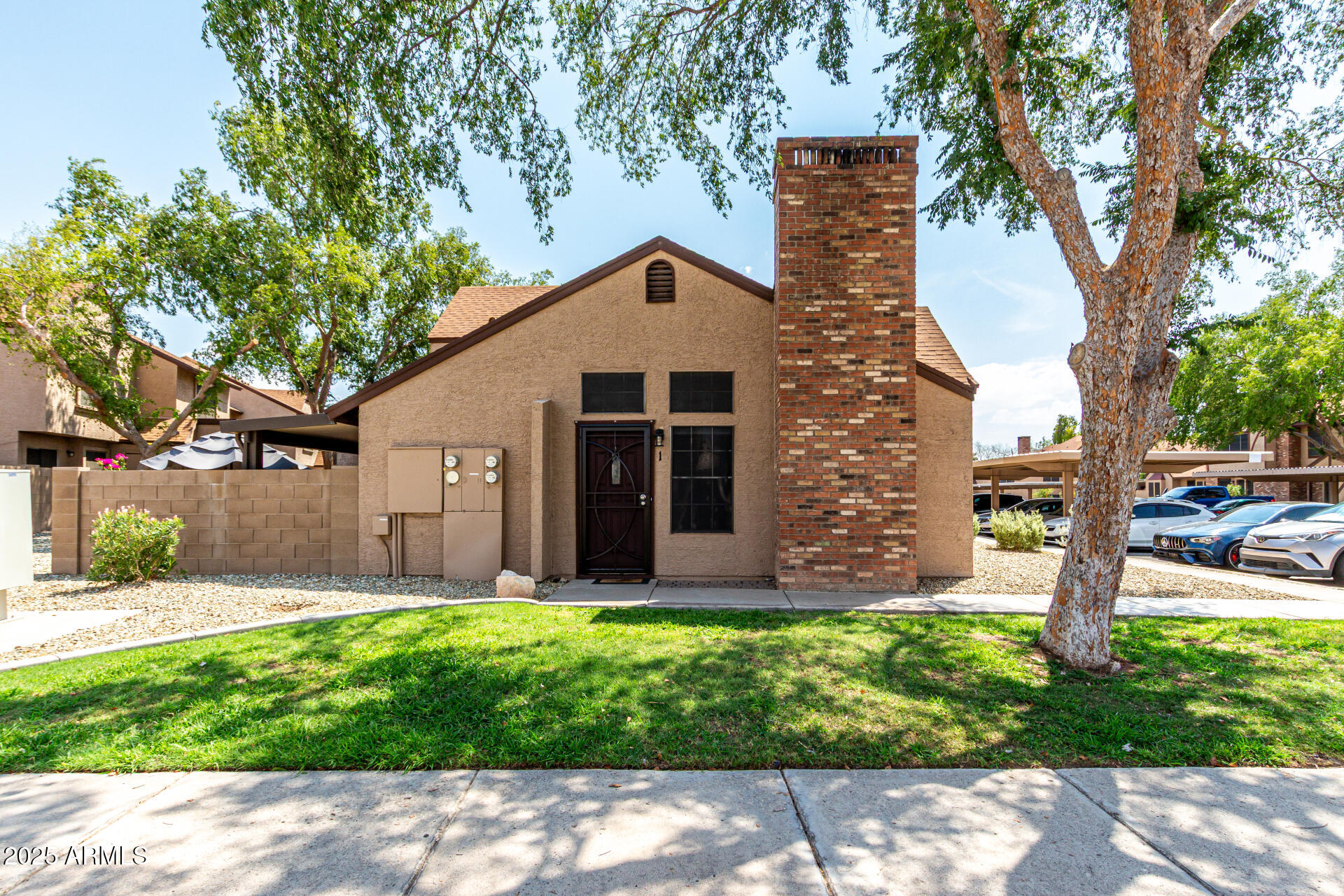 8111 West Wacker Road, Unit 1 Peoria, AZ 85381 - Photo 23 of 26 a front view of a house with garden