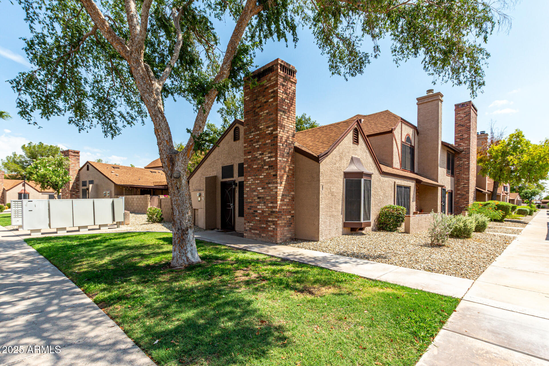 8111 West Wacker Road, Unit 1 Peoria, AZ 85381 - Photo 25 of 26 a front view of a house with garden