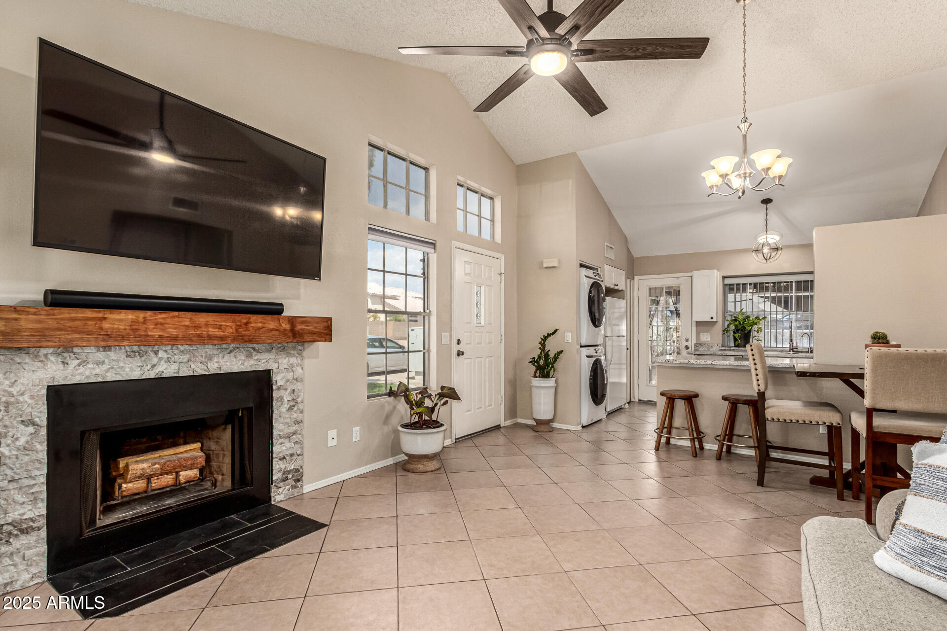 8111 West Wacker Road, Unit 1 Peoria, AZ 85381 - Photo 3 of 26 a living room with furniture a flat screen tv and kitchen view