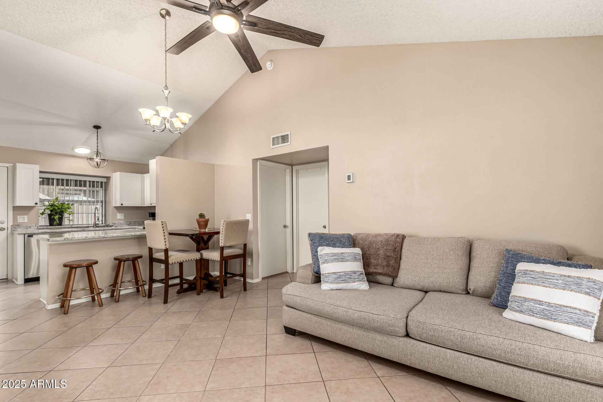 8111 West Wacker Road, Unit 1 Peoria, AZ 85381 - Photo 4 of 26 a living room with furniture and a chandelier