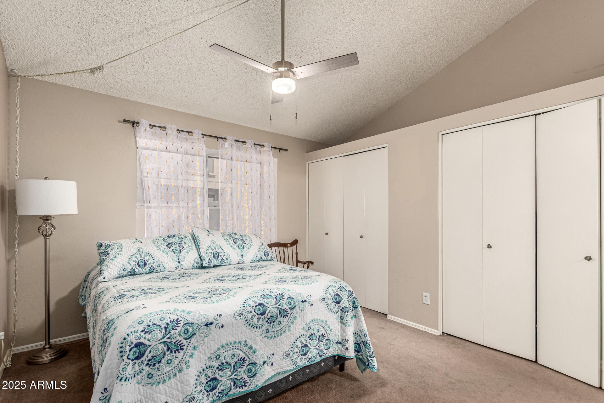 8111 West Wacker Road, Unit 1 Peoria, AZ 85381 - Photo 6 of 26 a bedroom with a bed and a chandelier