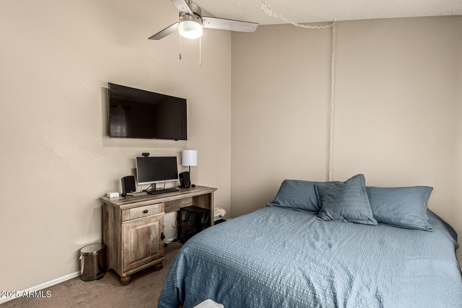8111 West Wacker Road, Unit 1 Peoria, AZ 85381 - Photo 7 of 26 a bedroom with a bed and a flat screen tv