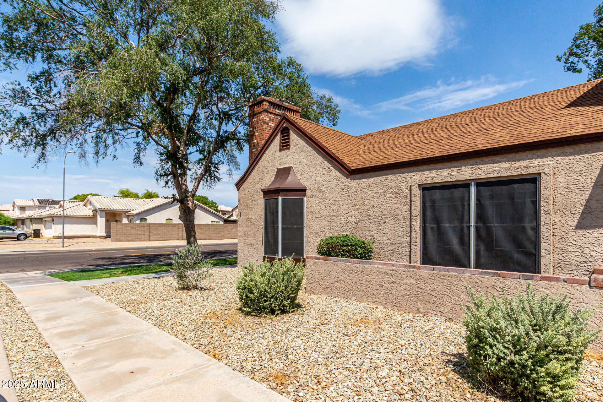 8111 West Wacker Road, Unit 1 Peoria, AZ 85381 - Photo 9 of 26 a front view of a house with garden