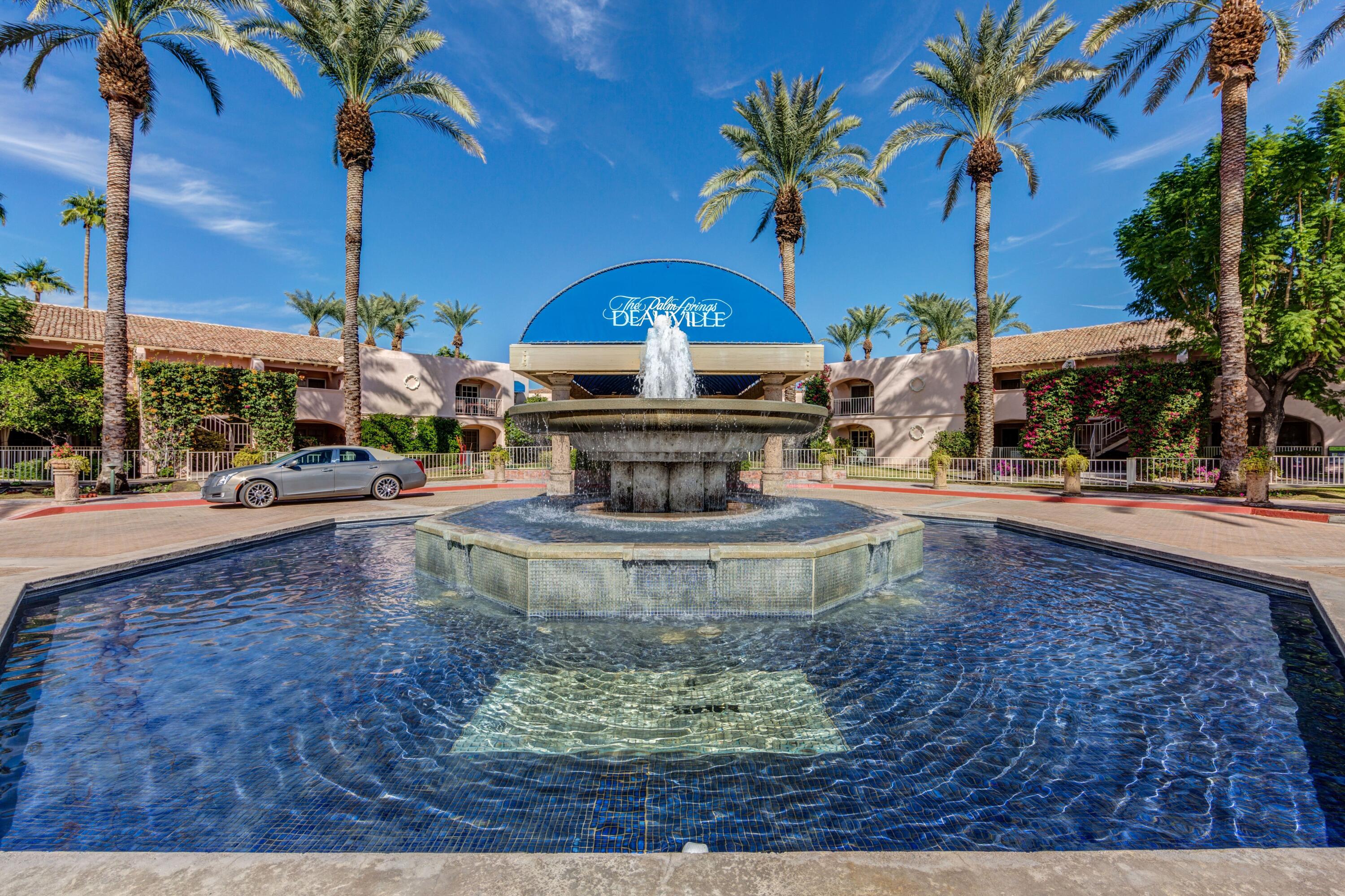 a view of a fountain in the middle of a yard
