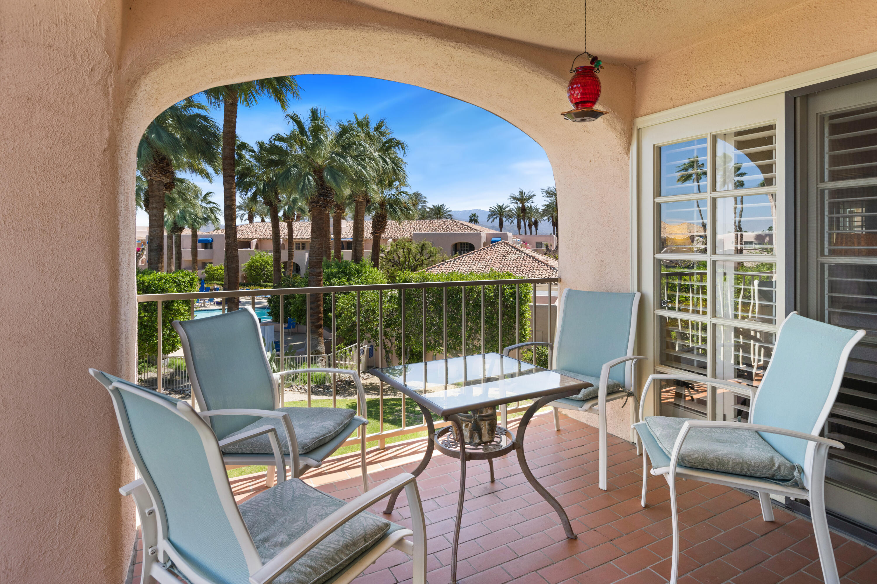 500 East Amado Road, Unit 613 Palm Springs, CA 92262 - Photo 15 of 28 a view of a chairs and table in the patio