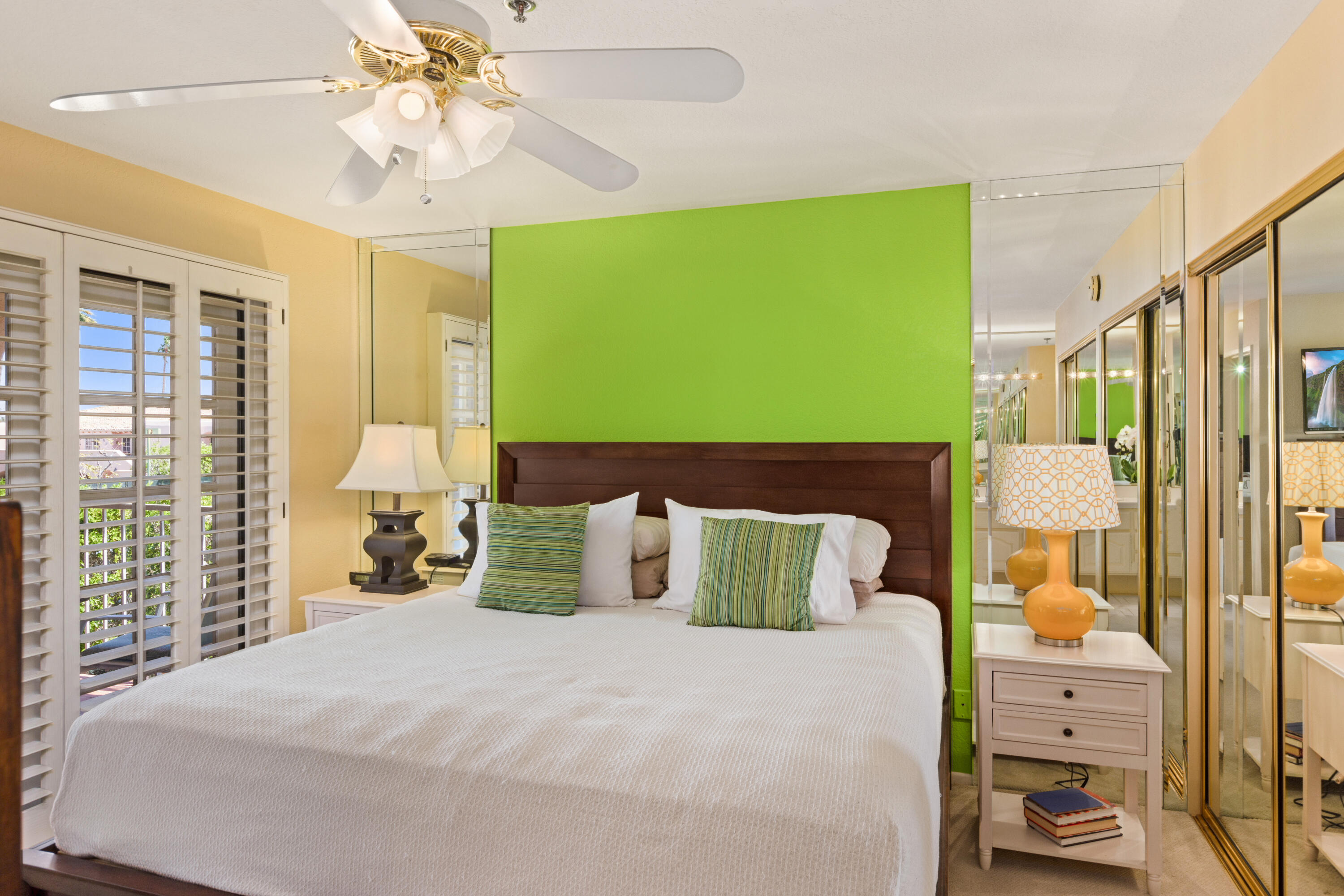 500 East Amado Road, Unit 613 Palm Springs, CA 92262 - Photo 19 of 28 a bedroom with a bed and a chandelier