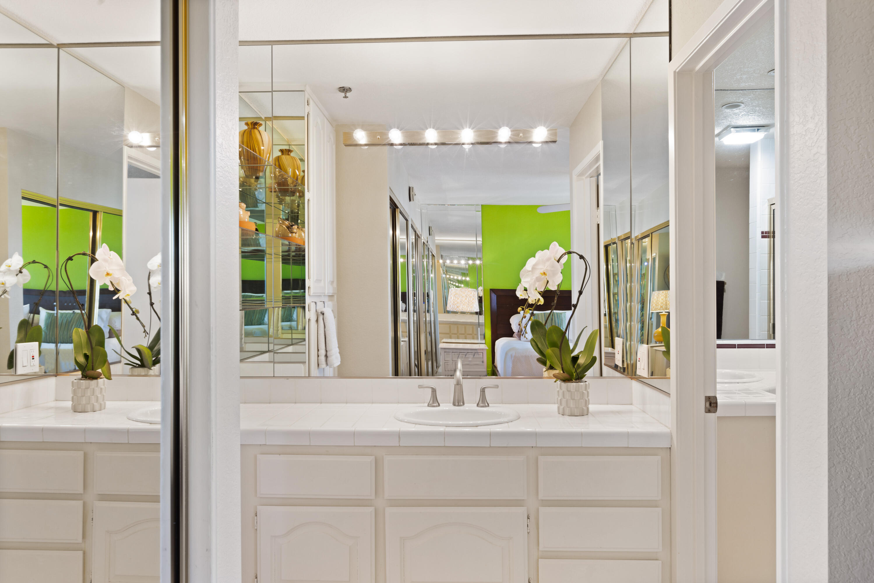 500 East Amado Road, Unit 613 Palm Springs, CA 92262 - Photo 21 of 28 a bathroom with a sink a mirror and a shower