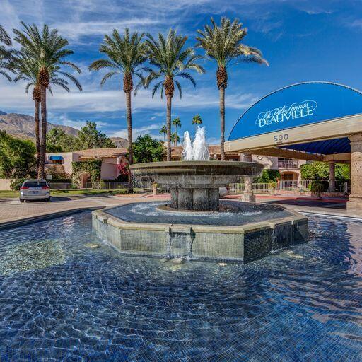 500 East Amado Road, Unit 613 Palm Springs, CA 92262 - Photo 27 of 28 a view of a swimming pool with a table and chairs