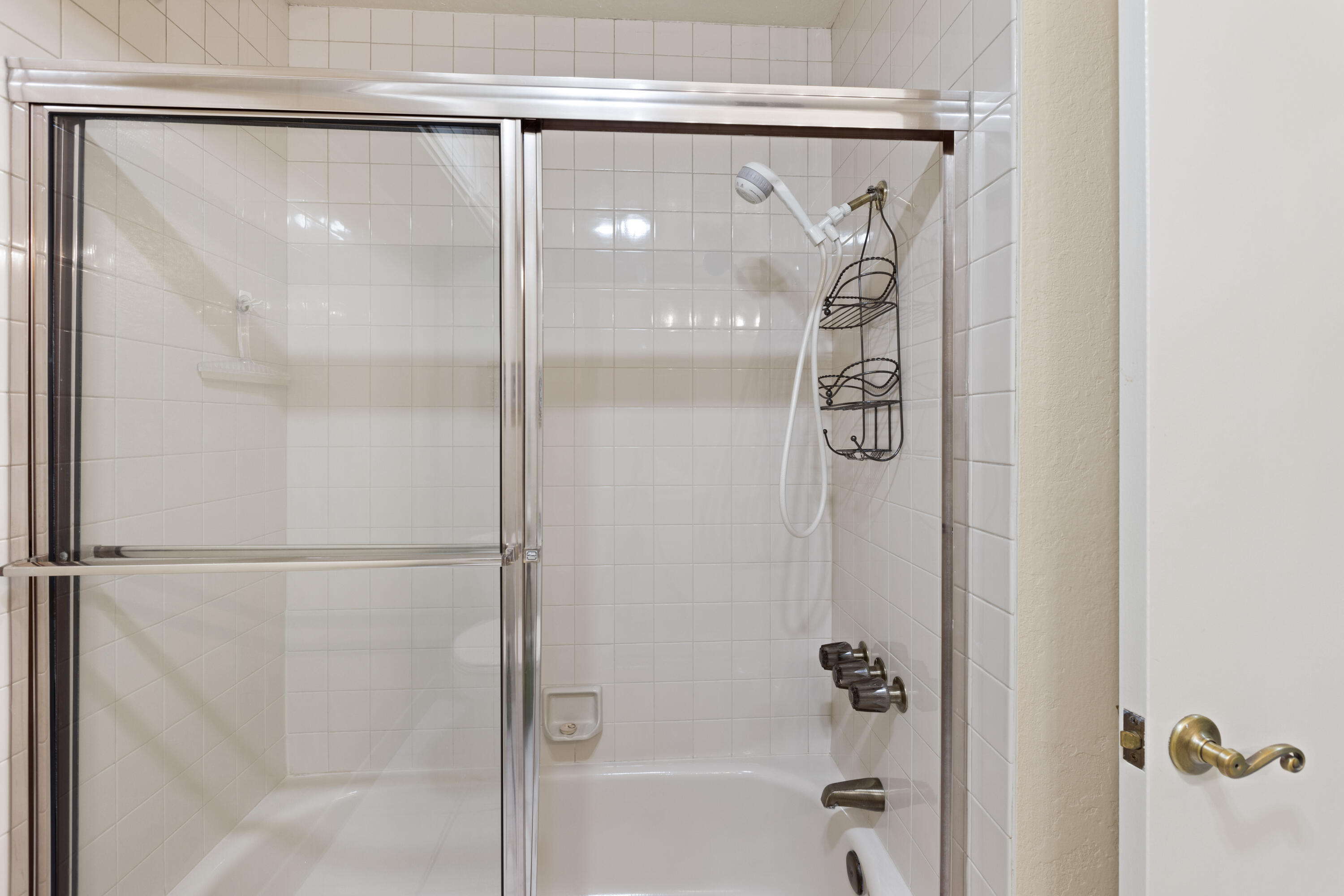 500 East Amado Road, Unit 613 Palm Springs, CA 92262 - Photo 9 of 28 a bathroom with a glass shower door