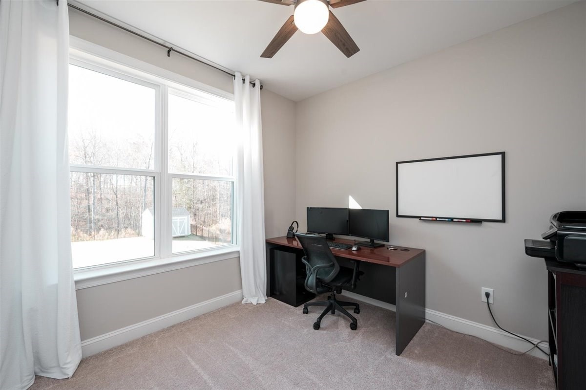 7056 Rex Road Holly Springs, NC 27540 - Photo 16 of 28 Use it as a guest bedroom, an office, a playroom, virtual school room, the choice is yours! First floor bedroom