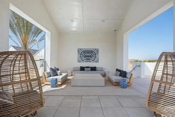 a view of backyard with swimming pool and seating space