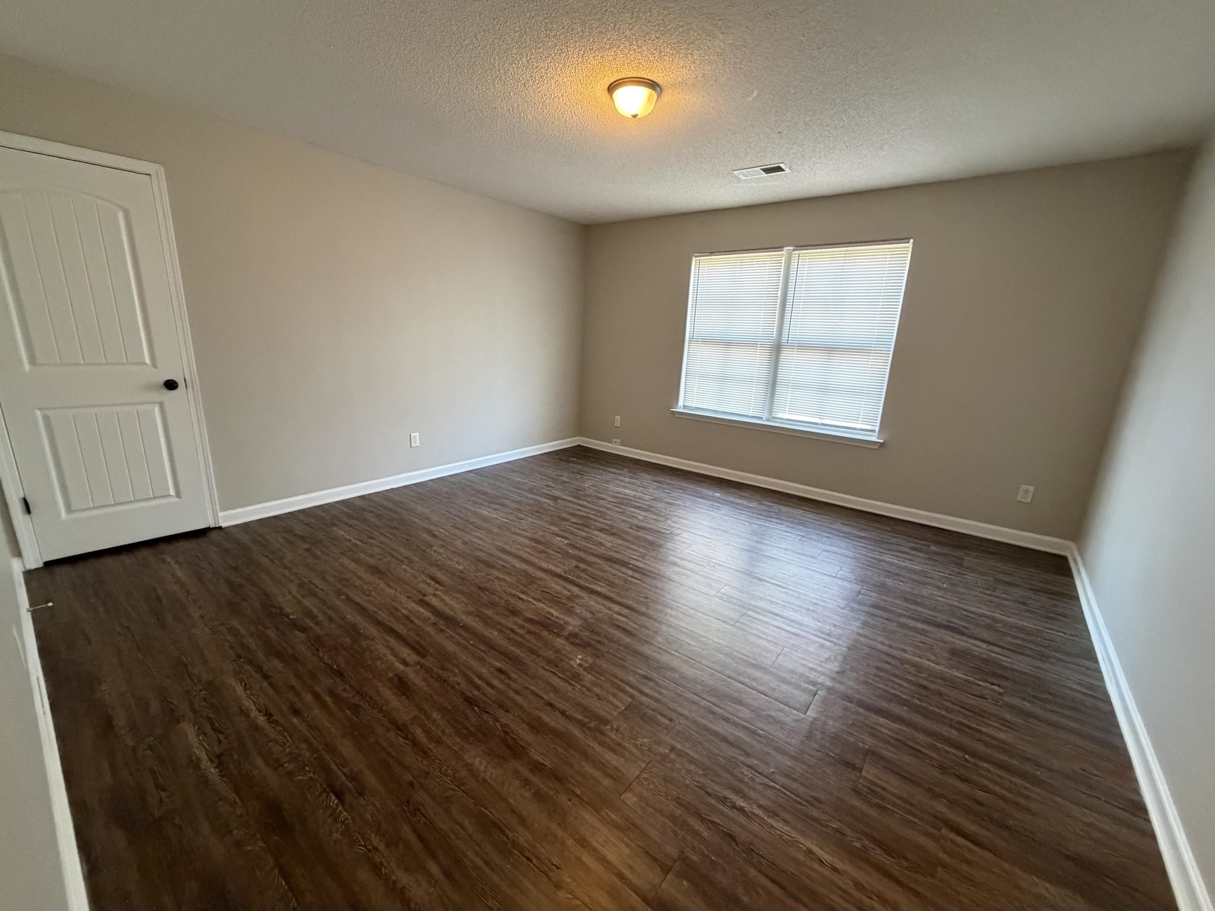 8712 Edney Ridge Drive Cordova, TN 38016 - Photo 12 of 18 an empty room with wooden floor and windows