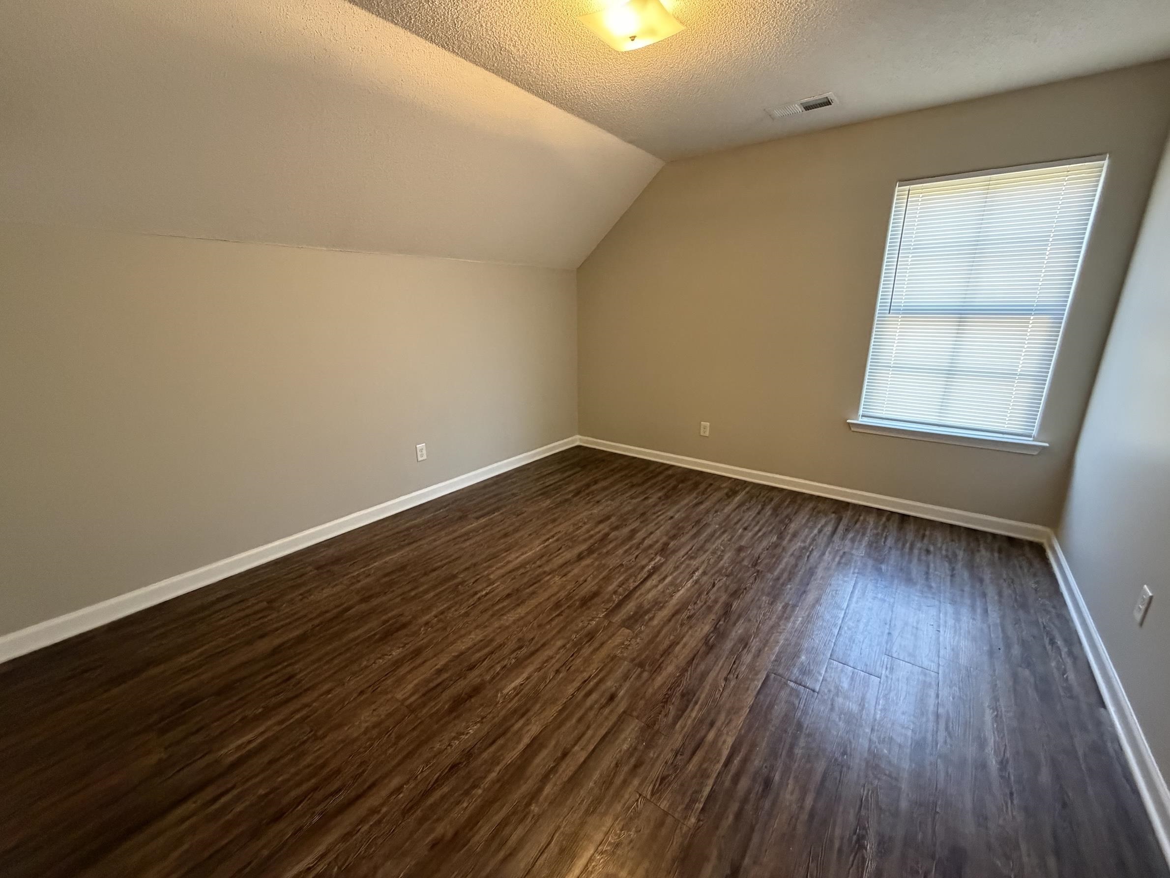 8712 Edney Ridge Drive Cordova, TN 38016 - Photo 13 of 18 an empty room with wooden floor and windows