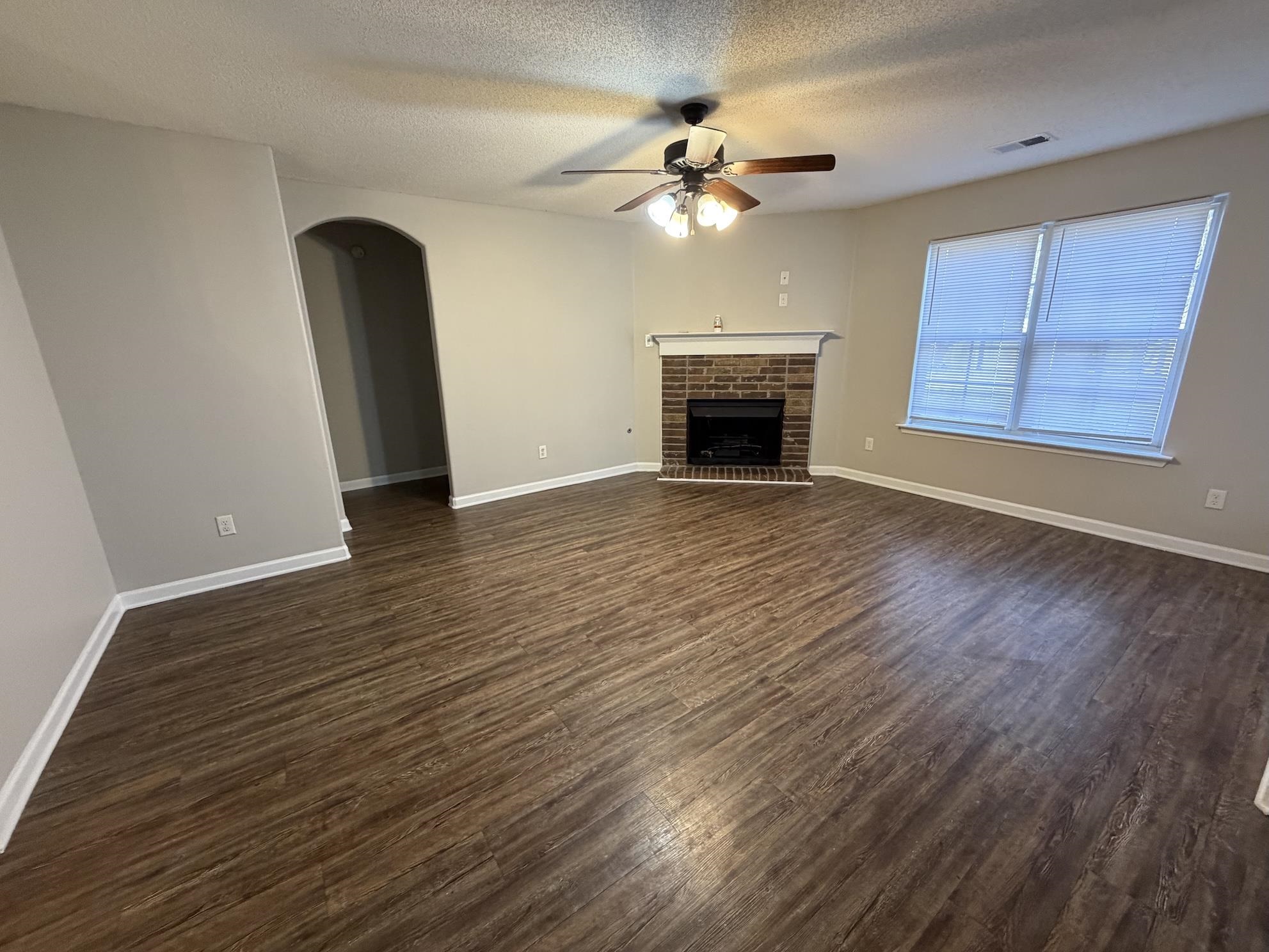 8712 Edney Ridge Drive Cordova, TN 38016 - Photo 3 of 18 an empty room with wooden floor fan and windows