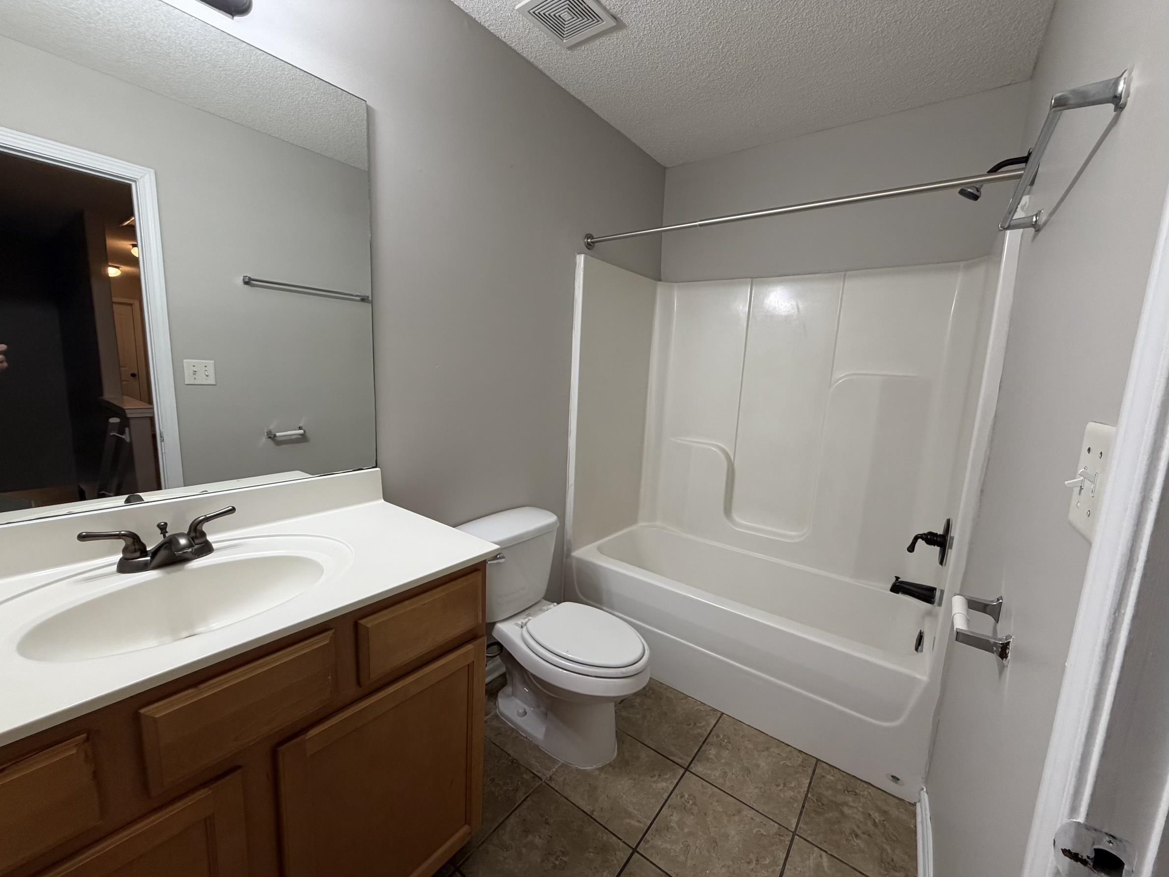 8712 Edney Ridge Drive Cordova, TN 38016 - Photo 4 of 18 a bathroom with a sink a toilet a mirror a vanity and shower