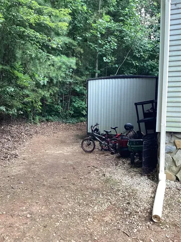a view of hen in the cage outside a house