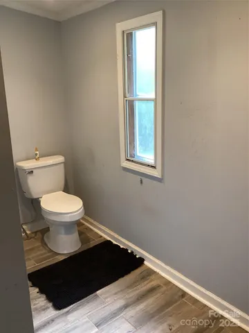 a bathroom with a toilet and a window