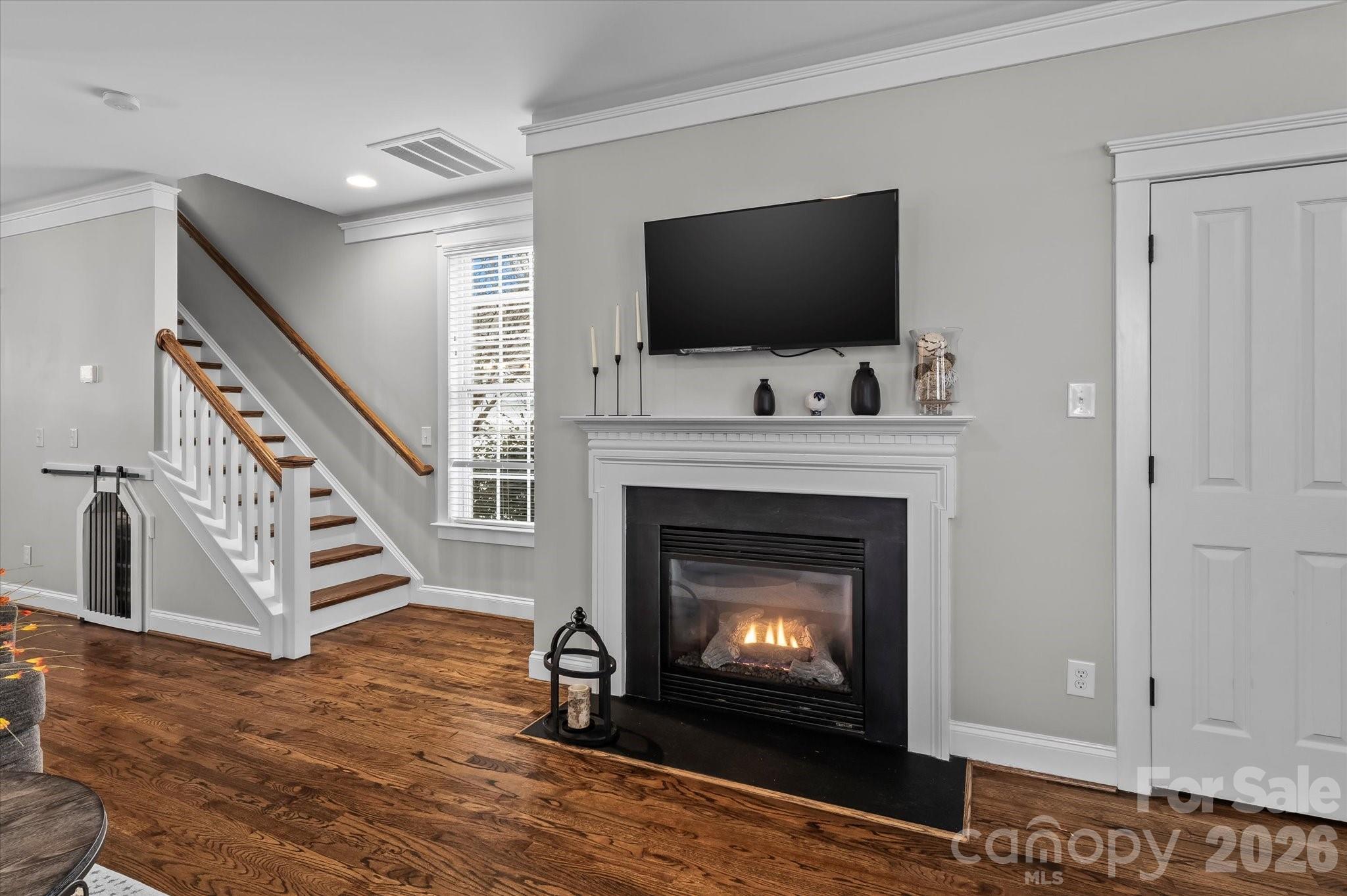 301 Bridges Farm Road Mooresville, NC 28115 - Photo 11 of 46 a living room with a fireplace a flat screen tv and a fireplace