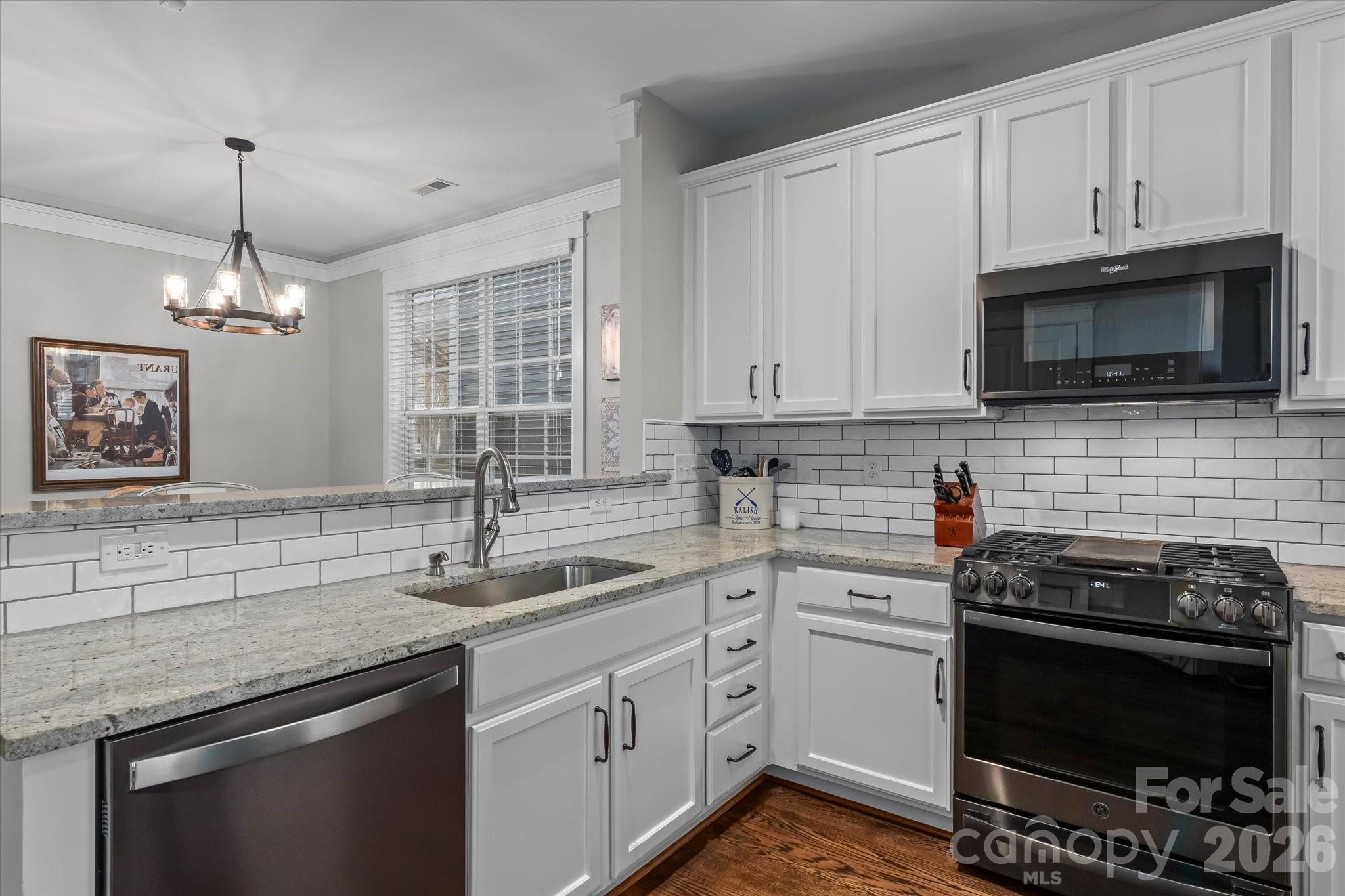 301 Bridges Farm Road Mooresville, NC 28115 - Photo 13 of 46 a kitchen with cabinets stainless steel appliances a sink and a window